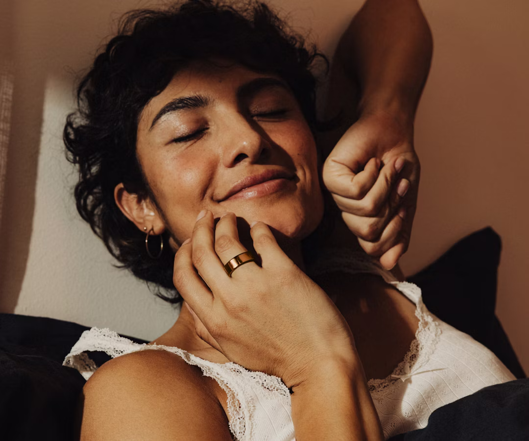 A person wearing a Rose Gold Oura Ring 4 waking up from sleep